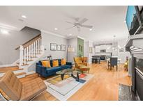 Inviting living room showcasing an open floor plan, staircase and hardwood floors at 404 S Camellia St, Chapel Hill, NC 27516