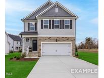 Charming two-story home with a stone-accented facade, a two-car garage, and a well-manicured front lawn at 428 Longleaf Glen Lane, Zebulon, NC 27597