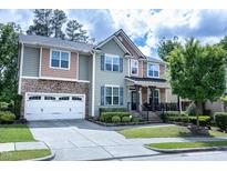 Beautiful home featuring stone accents, multi-colored siding and an attached two car garage at 5016 Trembath Ln, Cary, NC 27519