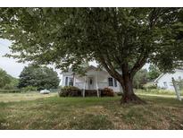 Charming home with lush green lawn and large shade tree at 6 1St St, Franklinton, NC 27525