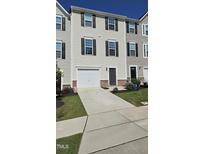 Charming townhome with a one car garage and a well-maintained front lawn at 904 Romeria Dr, Durham, NC 27713
