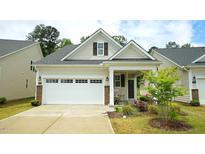 Charming home featuring a two-car garage, inviting front porch, and well-maintained landscaping at 1009 Morrison Dr, Durham, NC 27703