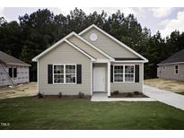 Charming single-Gathering home features a well-manicured lawn, black shutters, and a classic white front door at 109 Ambergate Ct, Rocky Mount, NC 27804
