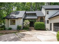 Exterior of the house with a stone facade entrance, well-maintained landscaping, and a driveway at 1120 Berwyn Way, Raleigh, NC 27615