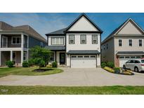 Charming two-story home featuring a two-car garage and beautifully landscaped front yard at 134 Cotten Dr, Morrisville, NC 27560