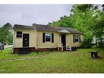 A charming single-story home with black shutters and a well-maintained lawn on an overcast day at 1620 Old Wilson Rd, Rocky Mount, NC 27801
