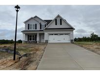 Two-story home featuring a two-car garage and a concrete driveway at 188 Tuskeegee Dr, Smithfield, NC 27577