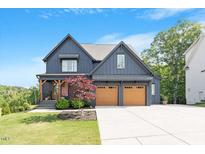 Charming two-story home featuring a two-car garage, covered entry, and well-manicured lawn at 2212 Plowridge Rd, Fuquay Varina, NC 27526