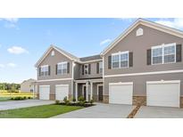 Beautiful gray two-story townhome with a two-car garage and well-manicured lawn at 232 Moyer Dr, Graham, NC 27253