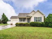 Charming single-story home featuring blue shutters and a well-manicured lawn at 253 Middle Landing Dr, Smithfield, NC 27577
