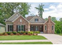 Charming, single-story home featuring a stone facade, manicured lawn, and inviting covered entrance at 2633 Beckwith Rd, Apex, NC 27523