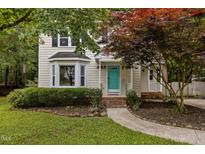 Charming two-story home featuring a bright teal door and beautifully landscaped front yard at 2705 Kempsford Pl, Raleigh, NC 27604