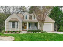 Charming home with beige siding, bay window, covered porch, and an attached one car garage at 318 Tillamook Dr, Wake Forest, NC 27587