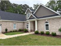 Charming brick home features manicured lawn, and arched windows at 4001 Newby Rd, Rocky Mount, NC 27804