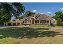 Sprawling home with a circular driveway, stone accents and a covered front porch at 4038 Carpenter Pond Rd, Durham, NC 27703