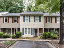 Charming townhome featuring neutral siding, brick accents, and neatly trimmed bushes at 4646 Fawnbrook Cir, Raleigh, NC 27612