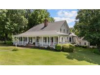 Charming home with a large, inviting porch and manicured lawn, perfect for relaxing and enjoying the outdoors at 5308 Stableview Ct, Holly Springs, NC 27540