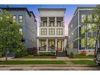 Charming three-story home with a welcoming front porch and manicured lawn at 610 Velma Hopkins Ln, Raleigh, NC 27603