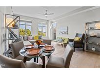 Bright living area features a dining table, comfortable seating, and natural light from large windows at 618 N Boylan Ave # 810, Raleigh, NC 27603
