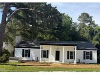 Charming single-story home featuring a covered porch with stately columns and black shutters at 65 Prospect Church Rd, Erwin, NC 28339