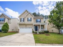 Charming two-story home with a well-maintained lawn and attached two car garage at 702 Crosstie St, Knightdale, NC 27545