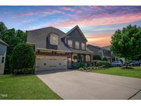 Charming two-story home featuring a well-manicured lawn, beautiful landscaping, and a spacious driveway at 82 Idlewood Ln, Clayton, NC 27527