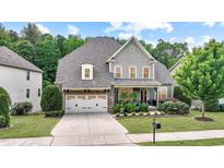 Charming two-story home featuring a well-manicured lawn, stone accents, and an attached two-car garage at 82 Idlewood Ln, Clayton, NC 27527
