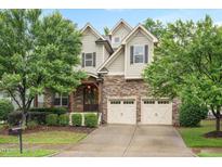 Charming two-story home with stone accents, a two-car garage, and mature landscaping at 821 Laurel Garden Way, Cary, NC 27513