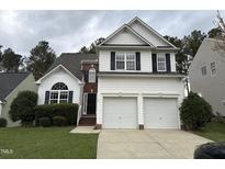 Charming two-story home with a two car garage, complemented by a well-maintained lawn and garden at 10 Gwendolyn Cir, Durham, NC 27703