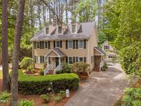 Charming two-story home with a well-manicured front yard, detached garage, and a cozy aesthetic at 108 Farren Ct, Cary, NC 27511