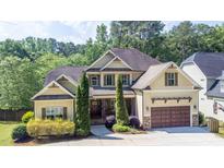 Charming two-story home featuring a manicured lawn, a two-car garage, and a welcoming front porch at 1101 Temple St, Raleigh, NC 27609
