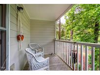 Cozy porch featuring wicker chairs and a hanging planter, perfect for relaxing outdoors at 121 Westview Dr # 22, Carrboro, NC 27510