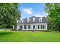 Charming two-story home featuring a well-manicured lawn and classic curb appeal at 124 Windmere Dr, Angier, NC 27501