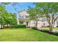Charming two-story home with a well-manicured lawn and attached two-car garage at 1605 Old London Way, Apex, NC 27523