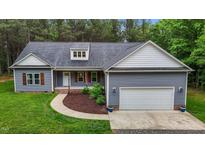 Charming one story home featuring a two-car garage, landscaped front yard, and inviting curb appeal at 1850 Willie Pace Rd, Burlington, NC 27217