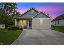 Charming single-story home featuring a well-maintained lawn and inviting front entrance, perfect for a cozy lifestyle at 2308 Buffalo Way, Durham, NC 27704