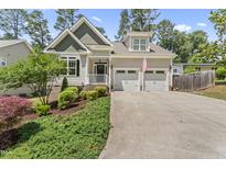 Charming home with a two-car garage, landscaped front yard, and an inviting entrance at 3914 Old Chapel Hill Rd, Durham, NC 27707