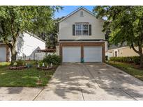 Charming two-story home featuring a two-car garage, brick accents, and well-manicured landscaping at 4216 Lake Woodard Dr, Raleigh, NC 27604