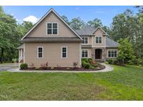 Charming two-story home with neutral siding, well-manicured lawn, and attractive landscaping at 4306 Infinity Ln, Durham, NC 27705