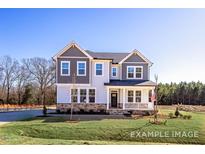Charming two-story home with a welcoming front porch and well-manicured lawn at 448 Golden Dragonfly St, Wake Forest, NC 27587