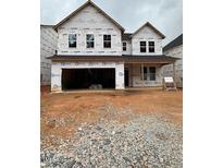 Two-story home under construction featuring a spacious two-car garage and visible window frames at 448 Golden Dragonfly St, Wake Forest, NC 27587