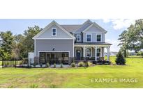 Charming two-story home with gray siding, inviting porch, and well-maintained lawn and black aluminum fence at 456 Golden Dragonfly St, Wake Forest, NC 27587