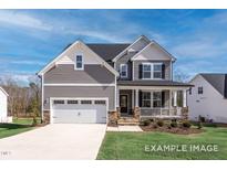 Charming two-story home with gray siding, stone accents, and a welcoming front porch at 456 Golden Dragonfly St, Wake Forest, NC 27587