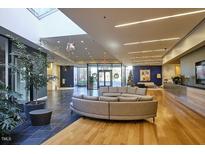 Bright lobby area with lounge seating and skylight, showcasing modern design elements and open space at 601 W Rosemary St # 712, Chapel Hill, NC 27516