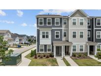 Charming two-story townhome featuring stone accents, neutral siding and well-manicured landscaping at 6352 Perry Creek Rd, Raleigh, NC 27616