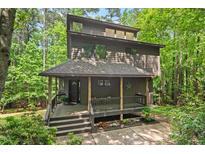 Stunning multi-story house featuring a cozy front porch and beautiful natural wood accents at 6412 Heartwood Dr, Chapel Hill, NC 27516