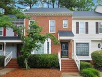 Charming brick townhome with well-maintained landscaping and inviting entrance at 6756 Olde Province Ct, Raleigh, NC 27609