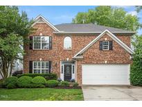 Charming brick two-story home with a well-manicured lawn and attached two car garage at 825 Federal House Ave, Wake Forest, NC 27587