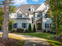 Beautiful two-story home with manicured lawn, landscaping and stone and shingle facade at 8709 Kimalden Ct, Wake Forest, NC 27587