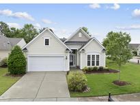 Charming single-story home with manicured lawn, attached garage, and well-maintained landscaping at 923 Peltier Dr, Cary, NC 27519